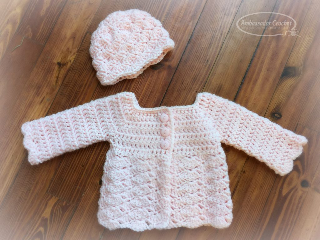 Sweet Shells Baby Sweater Crochet Pattern - This 0-3 month baby sweater is a free crochet pattern by Ambassador Crochet.