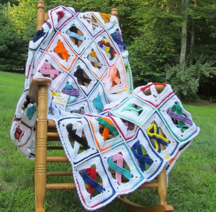 blanket over a rocking chair made with a bunch of awareness ribbons in different colors