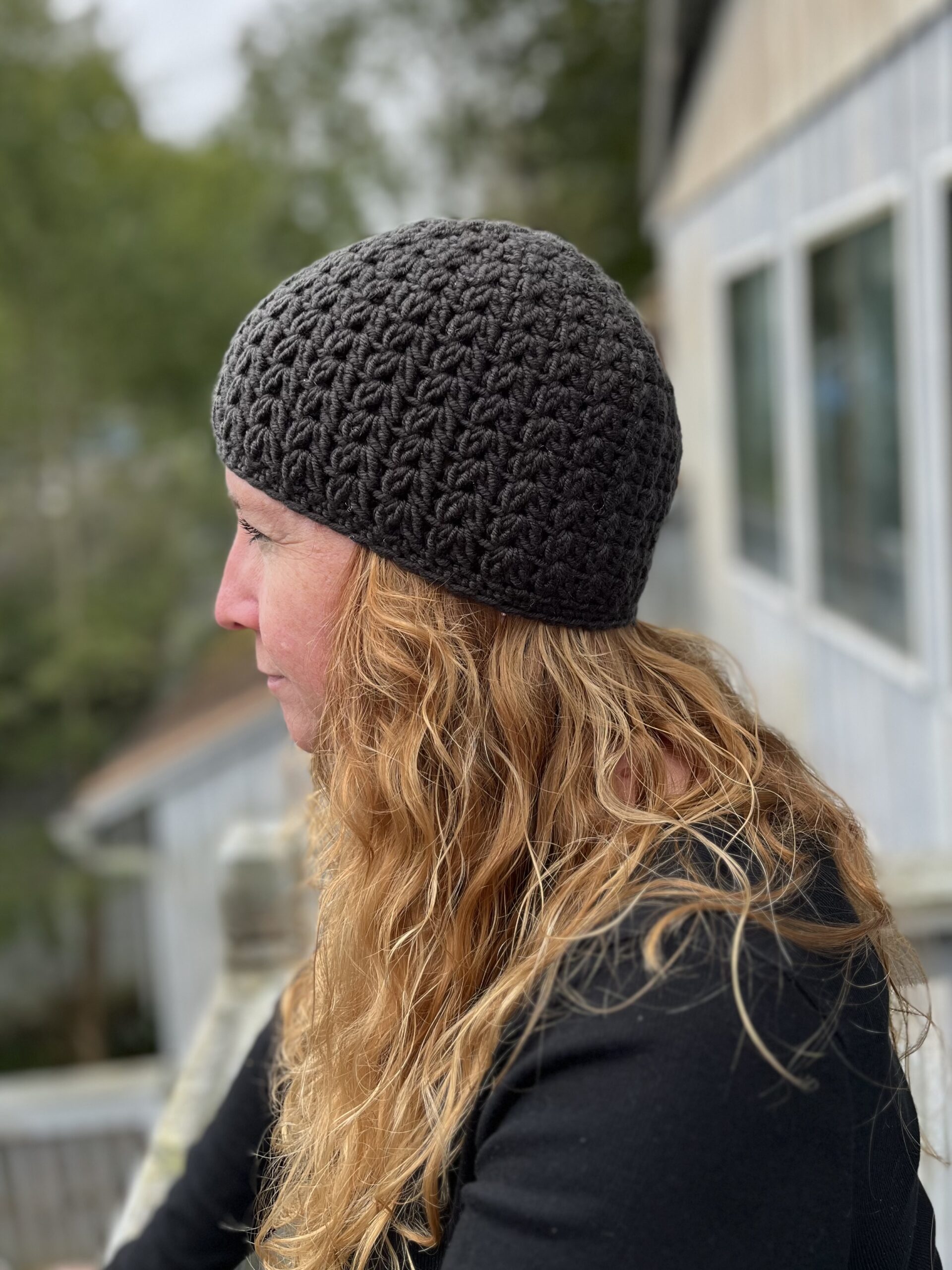 woman wearing a dark gray crocheted hat