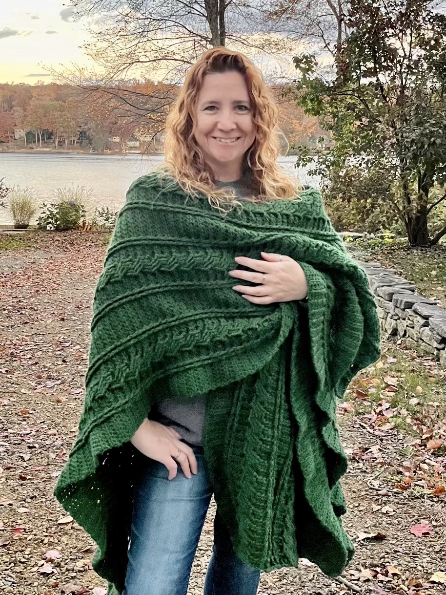 woman wearing an emerald green blanket wrapped around her shoulders